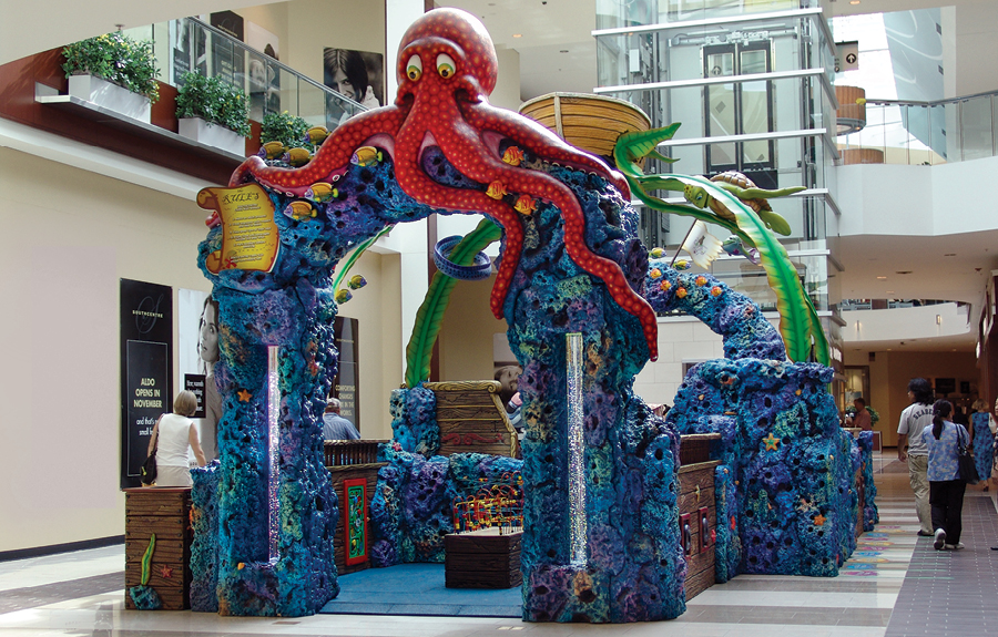 Kids play area in mall with colorful underwater theming, 3D foam animals and coral walls